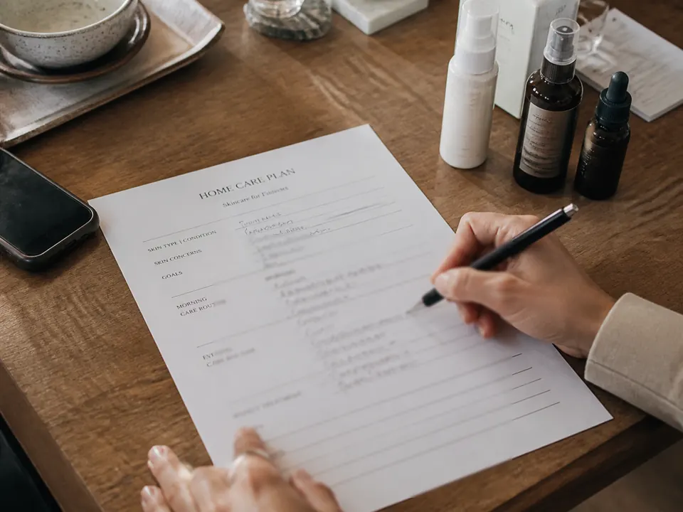 Facialist writing a client home care plan at a desk